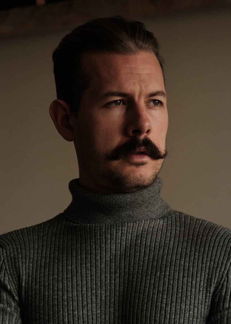 Close-Up Shot of a Man in Gray Turtleneck Sleeves